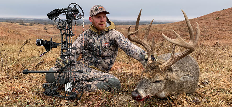 Bowhunter with harvested buck