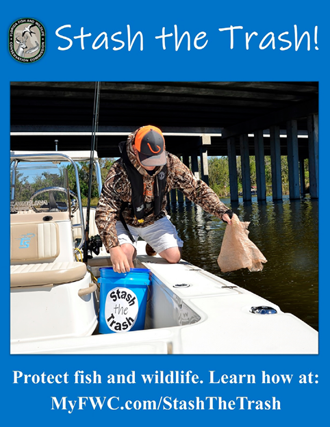Angler on a boat placing trash into a “Stash the Trash” bucket near a bridge, promoting responsible fishing and wildlife protection on Florida waters.