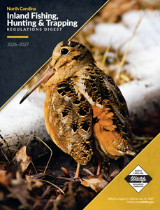 Cover of the 2026–2027 North Carolina Inland Fishing, Hunting & Trapping Regulations Digest featuring an American woodcock standing on a snowy forest floor, published by the North Carolina Wildlife Resources Commission.