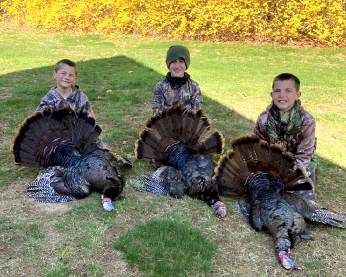 Three Youth Turkey Hunters with their Harvested Turkeys