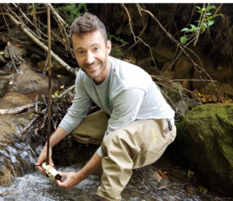 Senior Biologist Scott Collenburg checking a stream temperature logger.