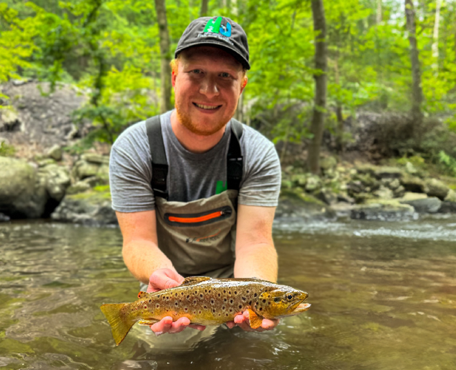 Fisheries Biologist Justin Rozema displaying a colorful catch from the Wild Brown Trout Enhancement section of the Pequannock River.