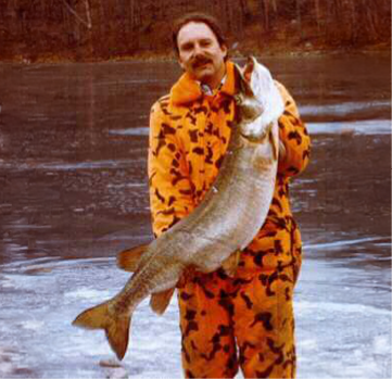 Bob Neals holding a 42 lb. 13 oz. state record muskellunge caught through the ice at Monksville Reservoir in 1997.