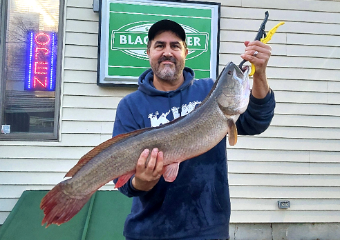 Frank Hubert holding the New Jersey state record bowfin caught on December 17, 2024.