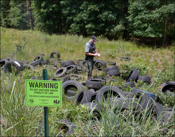 CPO Jonathan Malinski investigates illegal dumping at Tavern Rock Section of Peaslee Wildlife Management Area.