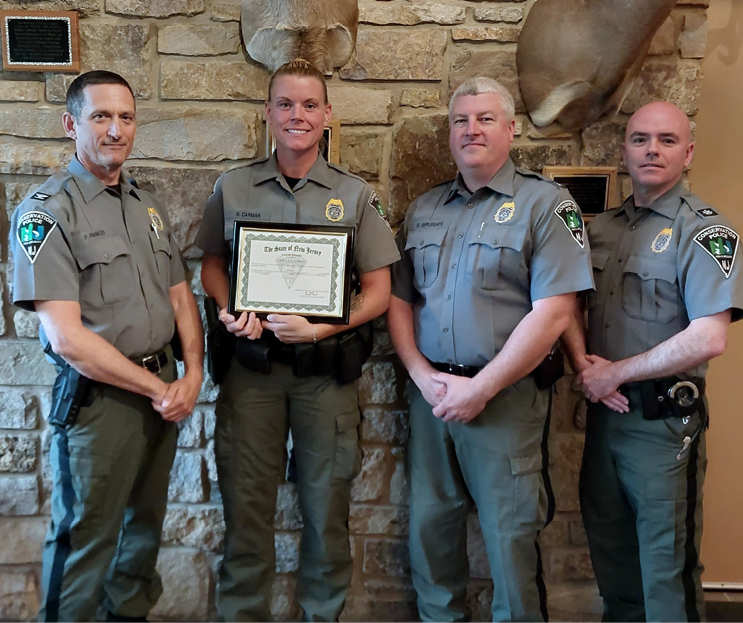 New Jersey Conservation Police Officer Nicole Carman receives the State of New Jersey Valor Award for her heroic work during the 2025 Jones Road Forest Fire. Pictured from left to right, Bureau Chief Frank Panico, CPO Nicole Carman, Deputy Chief Douglas Applegate, and Acting Deputy Chief Brian Scott. Photo by NJDEP Fish & Wildlife.