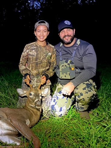 Youth hunter and adult with deer