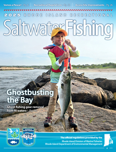 Child holding a large striped bass on a rocky shoreline, featured on the 2025 Rhode Island Saltwater Fishing regulations cover.